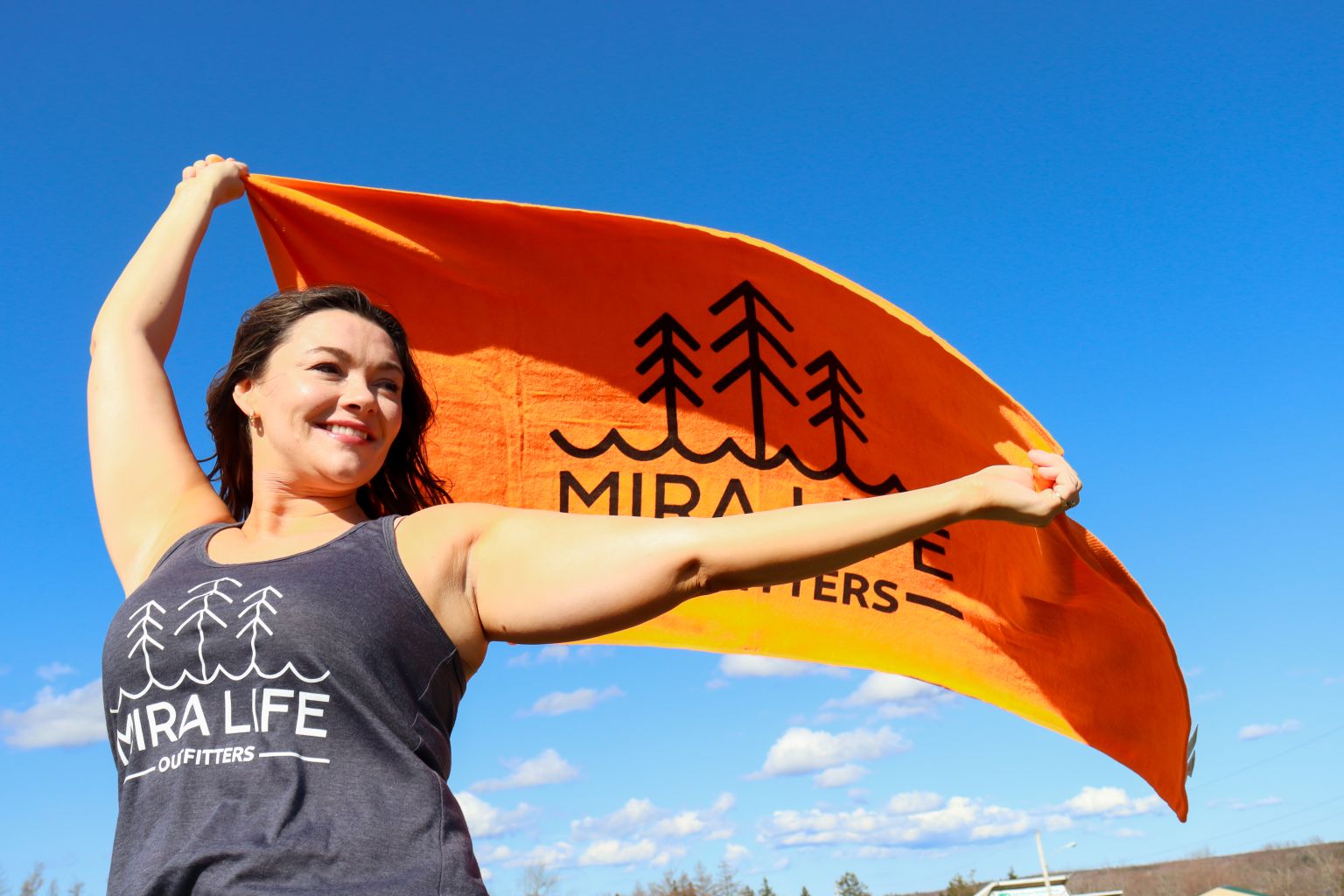 Mira Life Outfitters Spring Towels in the Colour Orange with Model wearing Spring Collection Tanktop
